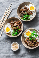 Japanese beef, rice and boiled egg bowl on grey background, top view. Asian food concept, flat lay