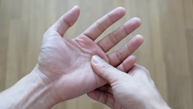 Hand of man pain trigger point with finger lock from office Syndrome. on white background .concept healthy care