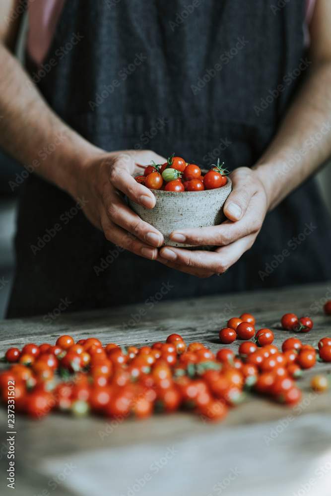 Wall mural Chef cooking with red cherry tomatoes - Wall murals