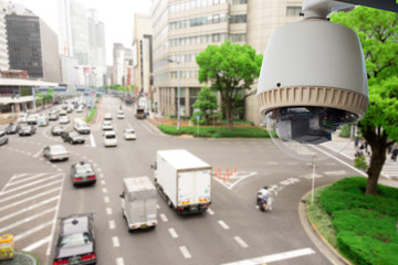 CCTV Surveillance camera operating on traffic road and people cross road in japan