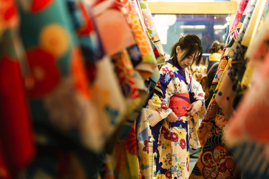 Young asian woman dress up with japanese kimono in kimono rental shop in japan