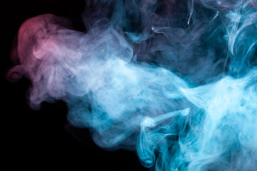 Multicolored pattern of the smoke of the blue and red colors of the mystical shape on a black isolated background. Abstract pattern in the form of waves and steam.