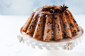 Traditional Christmas fruit cake, pudding on ceramic white stand. Top view. Copy space.