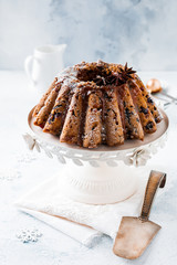 Traditional Christmas fruit cake, pudding on ceramic white stand. Top view. Copy space.