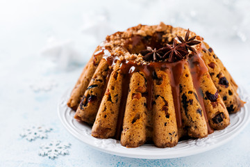Traditional Christmas fruit cake, pudding on white plate. Top view. Copy space.