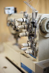 closeup details on sewing machine overlock. Workplace seamstress.Tailoring industry