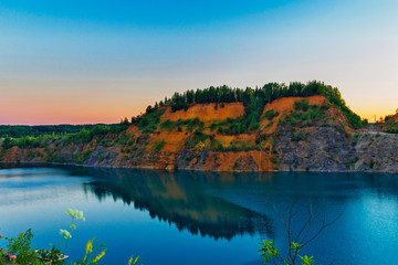 Fototapeta premium lake in a limestone quarry on a summer evening