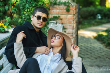 young couple in love on the streets of the autumn city . Young men in coats