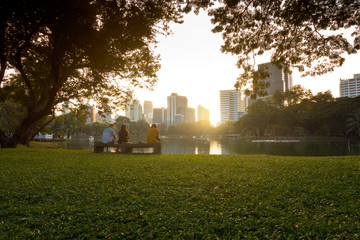 Bangkok city beautiful skyline at dusk, viewing from Lumphini Park with tourist are traveling here.