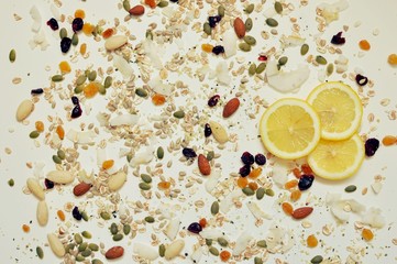 Close up of lemon slices, seeds and cereals on an white background. Top view, flat lay, close up
