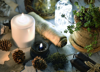 Black and white candles, cones, succulent and parchment on planks. Magic gothic ritual. Wicca,...