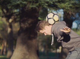 Soccer Player Balancing Football
