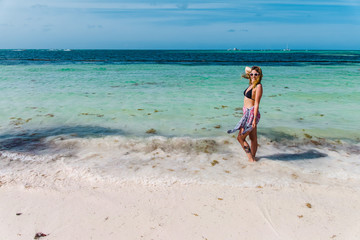 Fototapeta na wymiar Girl at Bavaro Beaches in Punta Cana, Dominican Republic