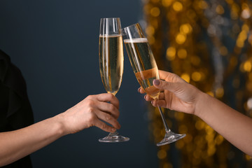 Friends clinking glasses with champagne at party