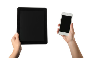 Young woman holding tablet PC and mobile phone on white background