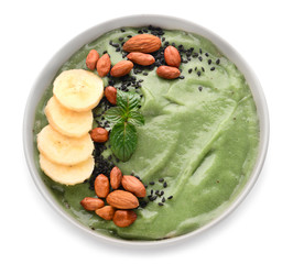 Bowl with tasty spirulina smoothie on white background