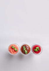 Glasses of tasty smoothies on grey background