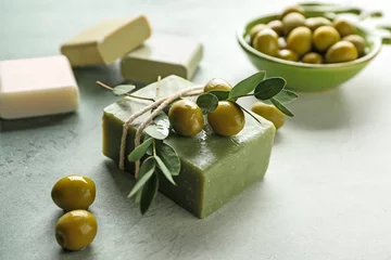Gordijnen Soap bars with olives on color table © Pixel-Shot