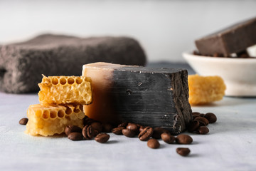 Soap bar with coffee beans and honeycombs on color table