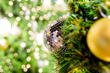 Decorating Christmas tree close up. Decoration bulb, fir tree