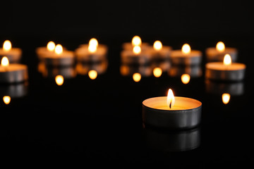 Burning candles on dark background