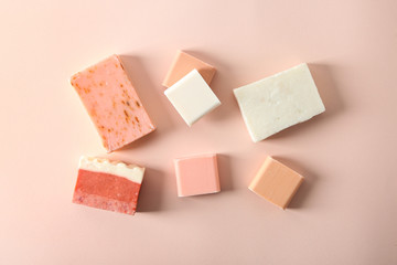 Handmade soap bars on color background, flat lay