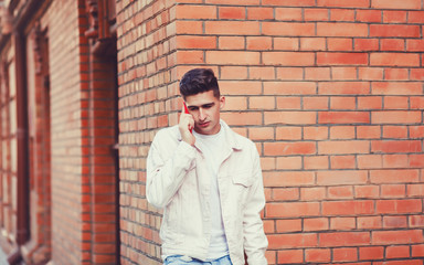Obraz premium Portrait of young stylish man talking with friend on phone