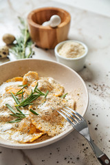 Plate with tasty ravioli on marble table