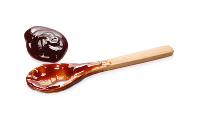 hip jam, marmalade with wooden spoon isolated on white background and texture