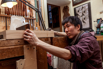 craftsman japaneese violinmaker began working on a new violin - obrazy, fototapety, plakaty
