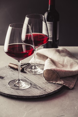 Glasses of red wine on concrete background