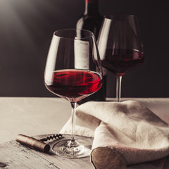 Glasses of red wine on concrete background