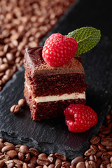 Closeup of chocolate cake with raspberry .