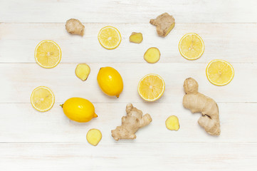 Fresh ginger root and lemon on white wooden background. Flat lay, top view, copy space. Minimalistic style, seasoning, spice, ingredient for tea. Concept healthy food, medicine, improving immunity