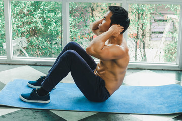 Asian men with beautiful muscles are doing sit-ups