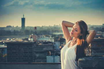 young beautiful city girl enjoy in sunset at rooftop summer
