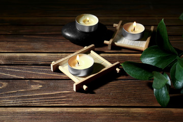 Burning candles on wooden background