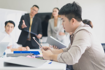 A group of Asian businessmen are discussing their work. portrait of male employee while presidents and secretaries were present.