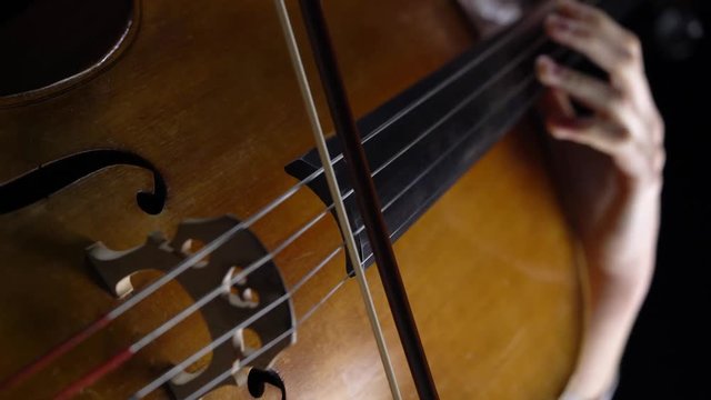 Closeup of a girl playing the cello