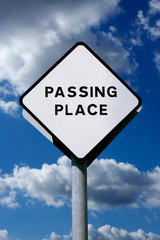 ROAD TRAFFIC PASSING PLACE INFORMATION SIGN WITH BLUE SKY BACKGROUND