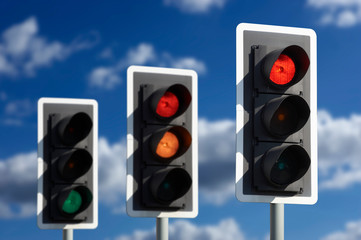 ROW OF THREE ROAD TRAFFIC LIGHTS SHOWING SEQUENCE OF RED AMBER AND GREEN