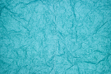 ABSTRACT RANDOM BACKGROUND OF CREASED CRUMPLED PALE BLUE TISSUE PAPER