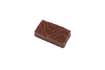 Sponge chocolate cake with cream filling isolated on white background.