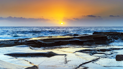 Soft Gold and Blue Hazy Sunrise Seascape from Rock Platform