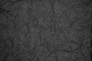 ABSTRACT RANDOM BACKGROUND OF CREASED CRUMPLED DARK GREY TISSUE PAPER