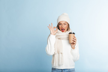 Happy young woman wearing sweater and hat