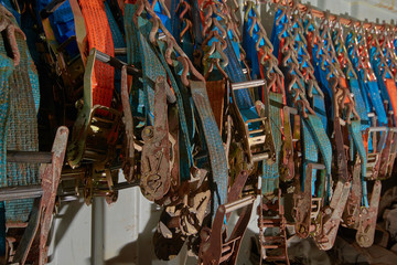 Plenty of polyester webbing lashing, lashing belts, straps and ratchets stowed in lashing container. Background.