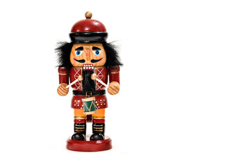 Merry Christmas: Traditional colorful vintage wooden nutcracker little drummer boy doll puppet isolated on white background and copyspace for text - concept festive Christmas decoration ornament