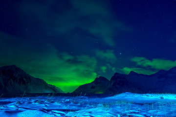 Snow-Covered Valley between Mountains and Aurora Borealis