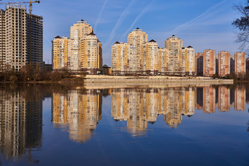 Magical View to the west of Krasnodar from the Kuban River in the winter at golden hours. New skyscrapers and clear blue sky reflected in the water surface.